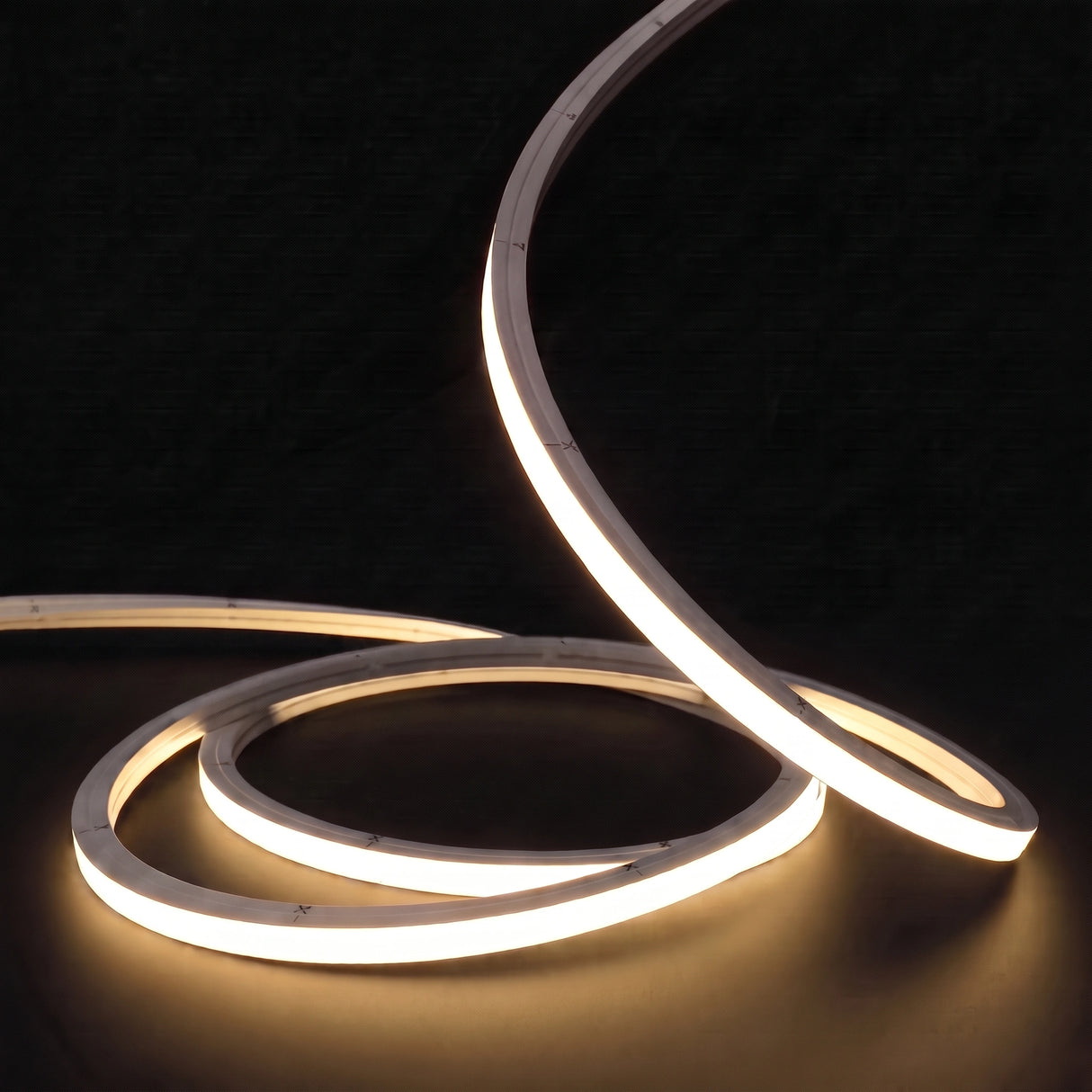 Warm White 3000K LED Neon Flex 15x15mm Top Bend, low concentric coils with raised arc and colour glow on a black surface