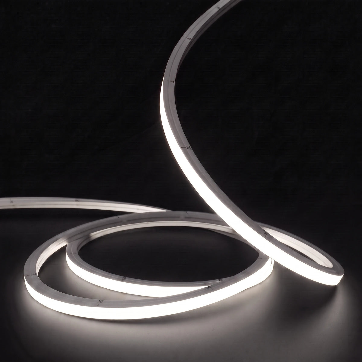 Neutral White 4000K LED Neon Flex 15x15mm Top Bend, low concentric coils with raised arc and colour glow on a black surface