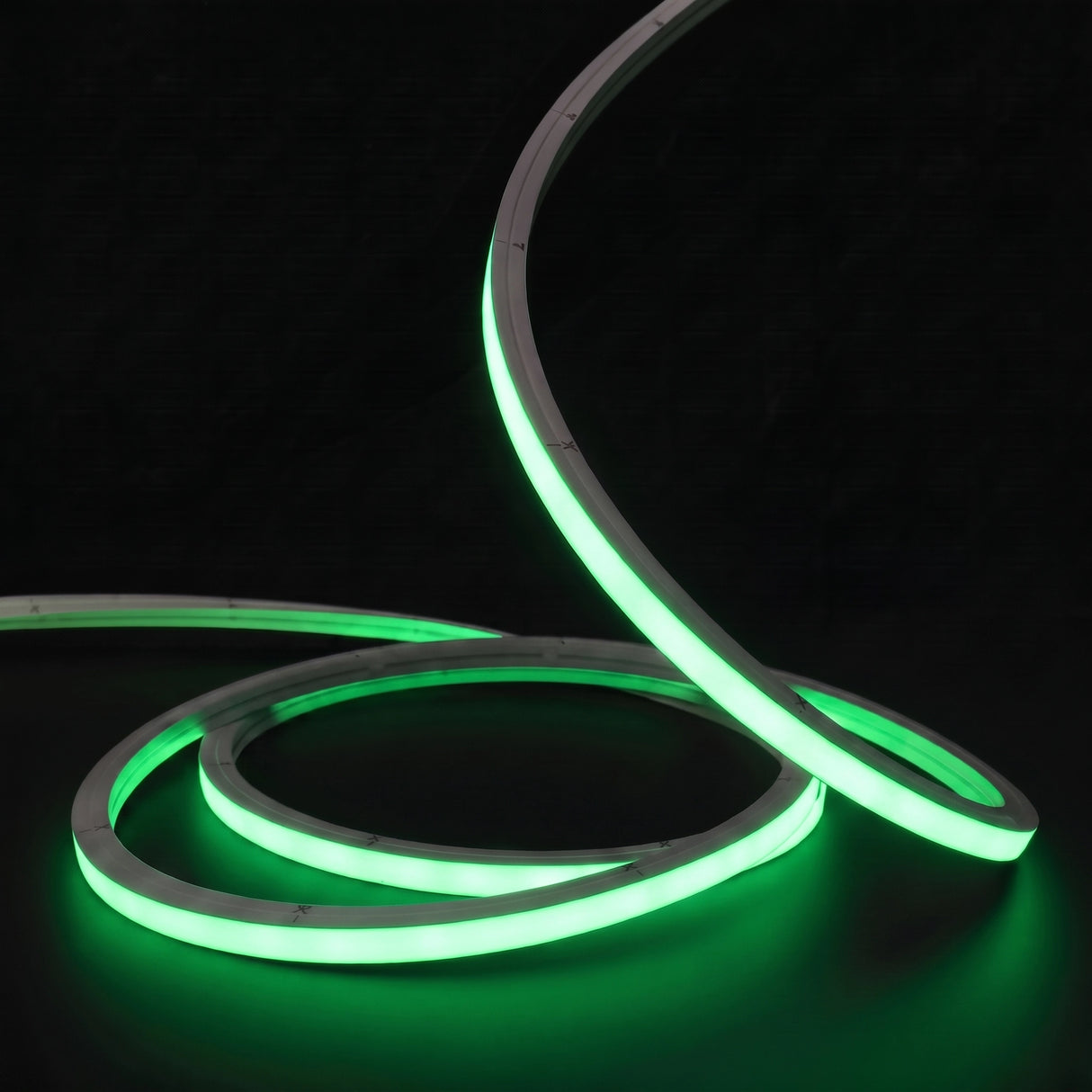 Green LED Neon Flex 15x15mm Top Bend, low concentric coils with raised arc and colour glow on a black surface
