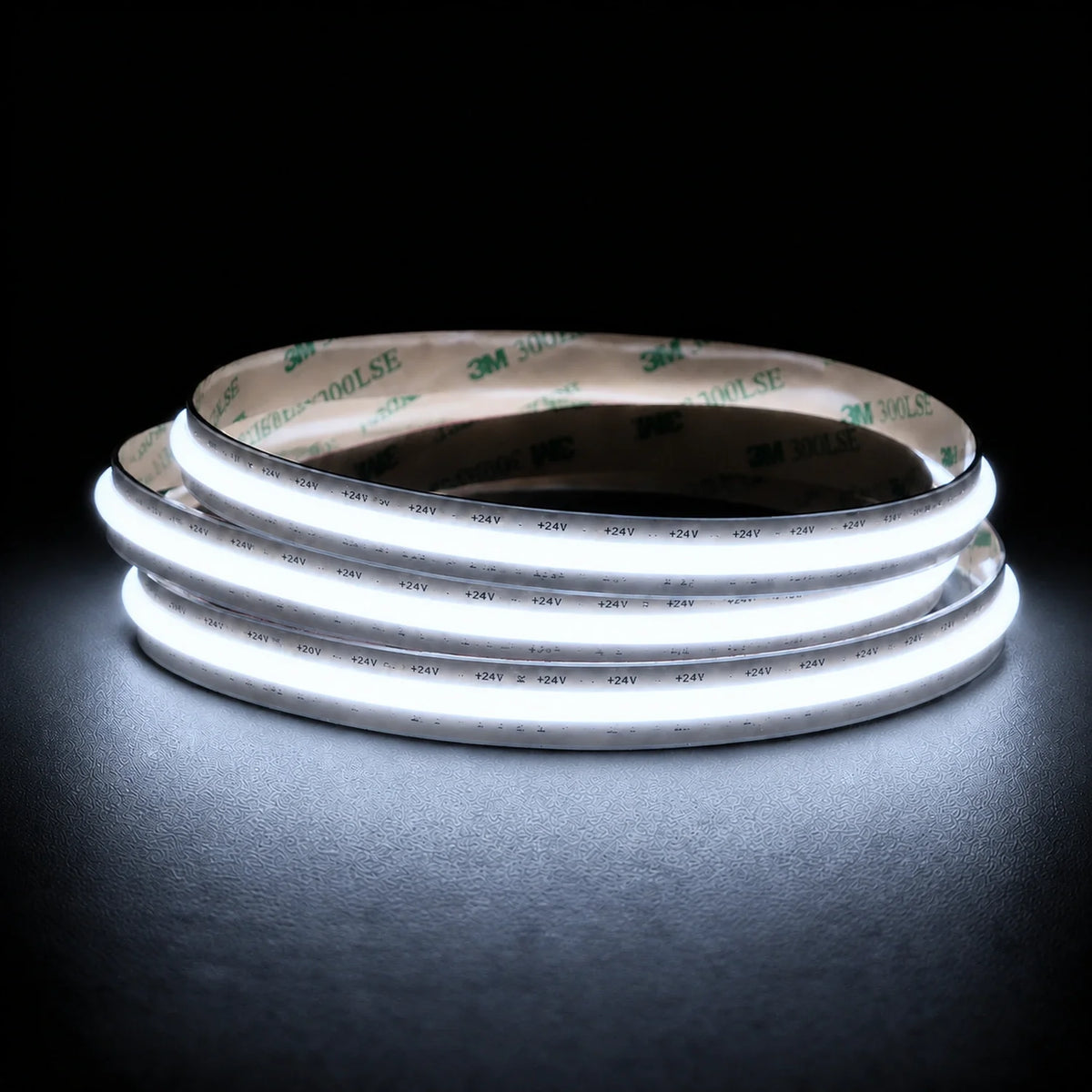 Cool White 6500K Free Cut COB LED strip illuminated coil on charcoal background