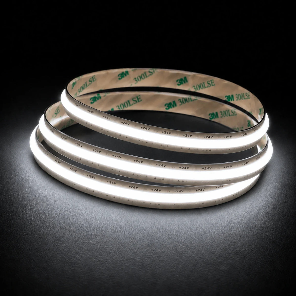 5000K Free Cut COB LED strip 24V 8mm IP20 illuminated coil on black background