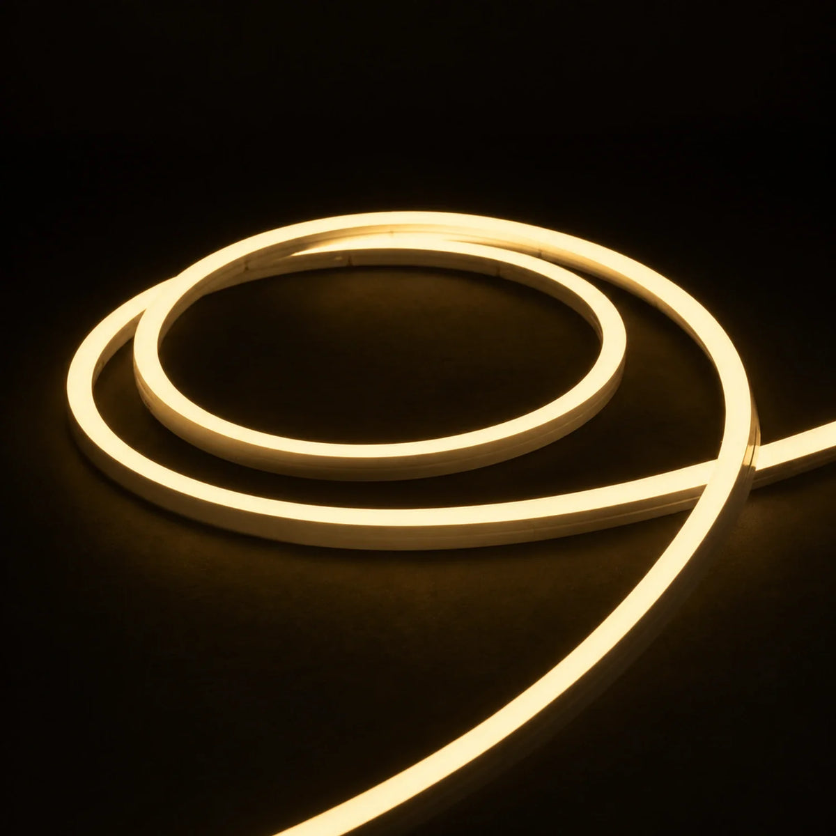 2700K side-bend Neon Flex coiled on a dark surface, colour-adjusted product photograph