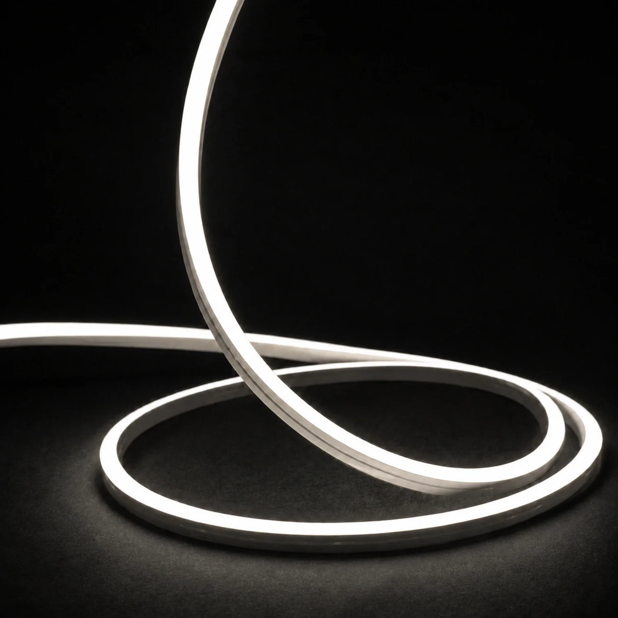 4000K side-bend Neon Flex raised in loops on a dark surface, colour-adjusted product photograph
