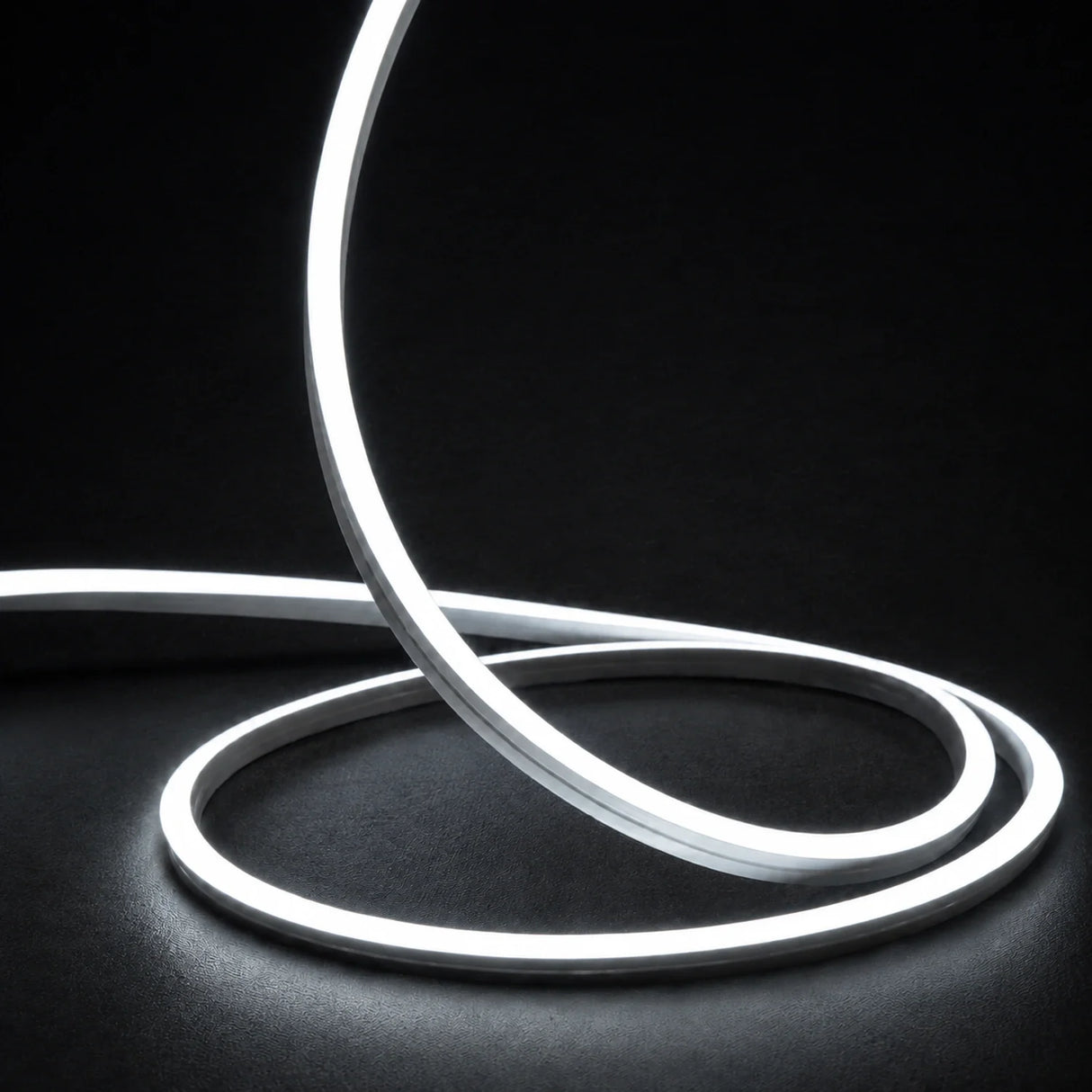 6000K side-bend Neon Flex raised in loops on a dark surface, colour-adjusted product photograph