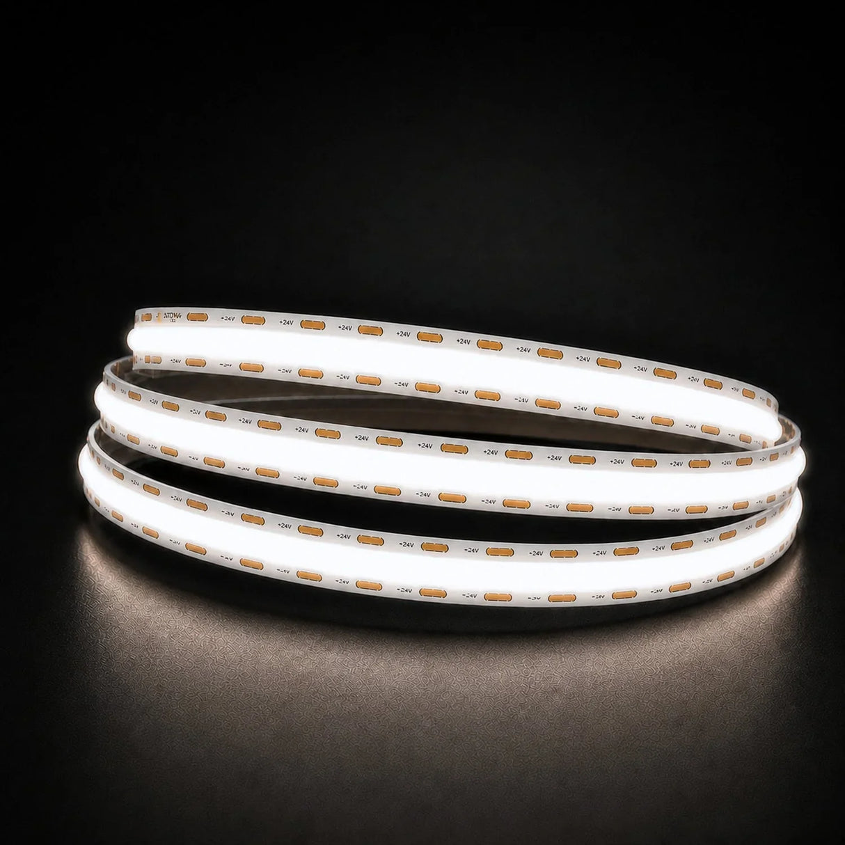 Daylight 5000K COB LED strip coil illuminated on a dark background, 24V DC and 10mm wide.