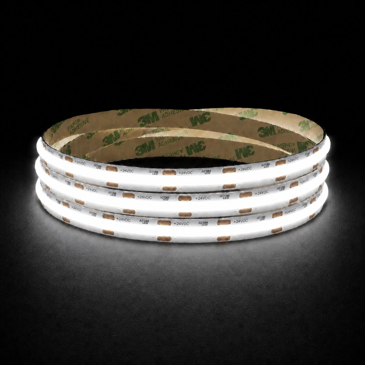 Daylight 5000K 24V 10mm COB LED strip shown illuminated in a coil on a dark background.