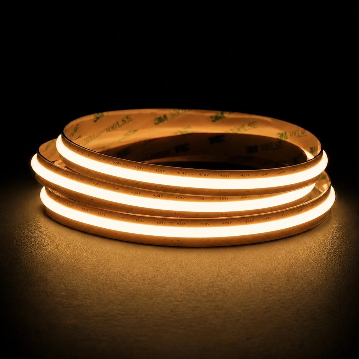 Warm White 2700K Free Cut COB LED strip coil illuminated on a dark background, 24V DC and 10mm wide.