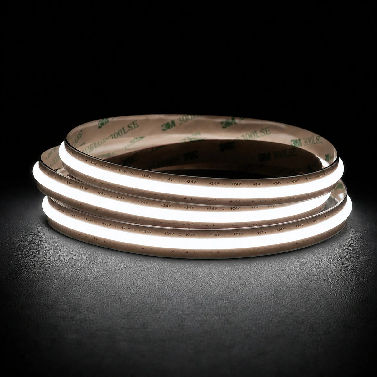 Daylight 5000K Free Cut COB LED strip coil illuminated on a dark background, 24V DC and 10mm wide.