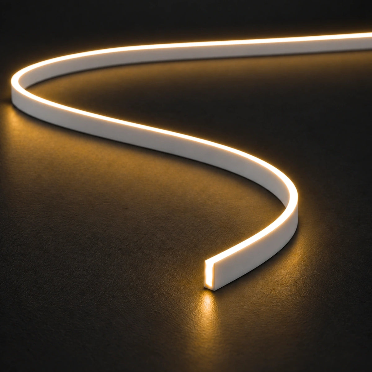 UK LED Lights FreeCut Mini Neon Flex 4x6mm 2700K warm white illuminated S-shaped strip on charcoal surface