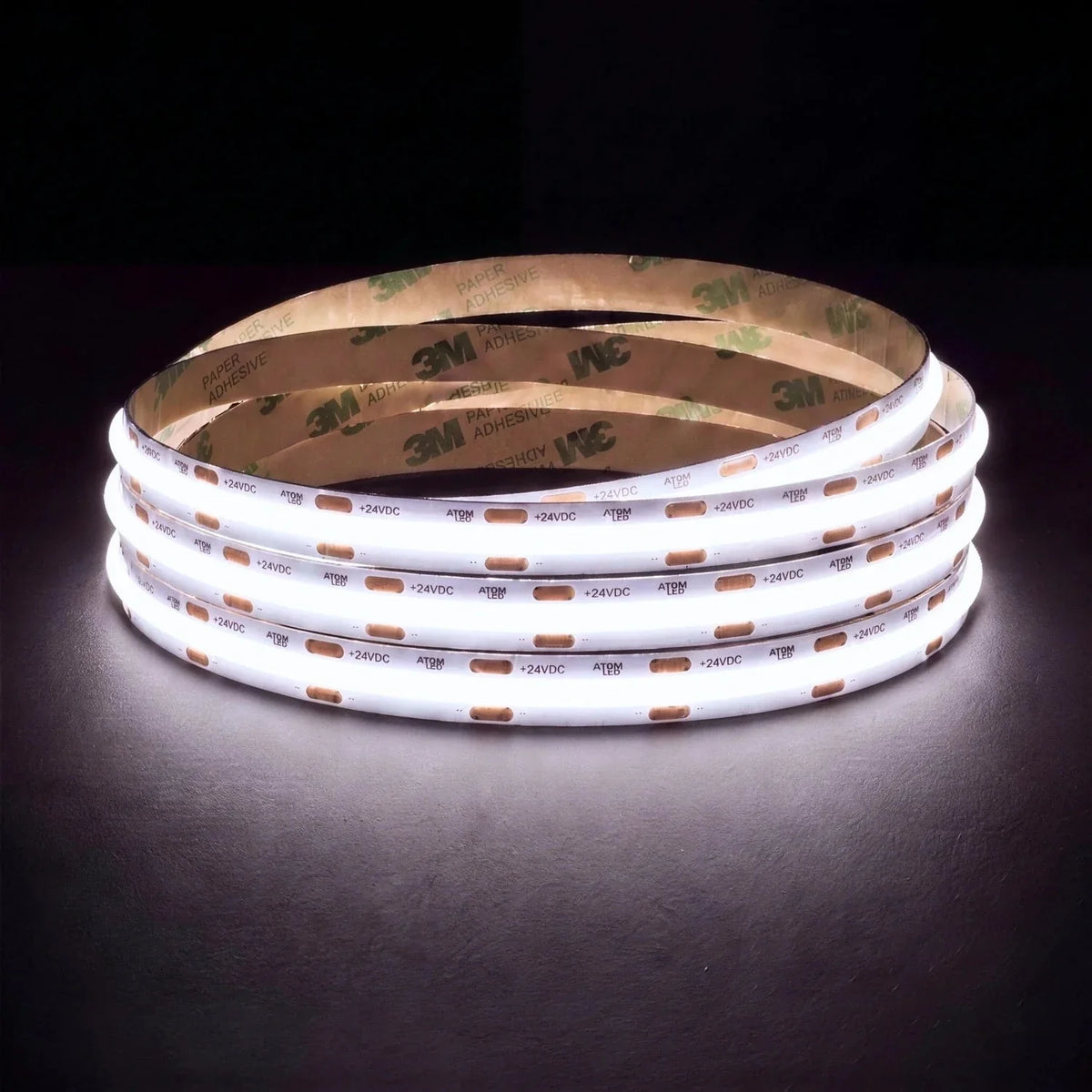 Daylight 5000K SCOB LED strip coil illuminated on a dark background, 24V DC and 10mm wide.