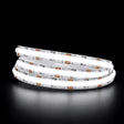 Daylight 5000K COB LED strip illuminated in a coil against a black background