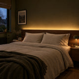 Warm white 3000K LED strip lighting installed behind a bedroom headboard