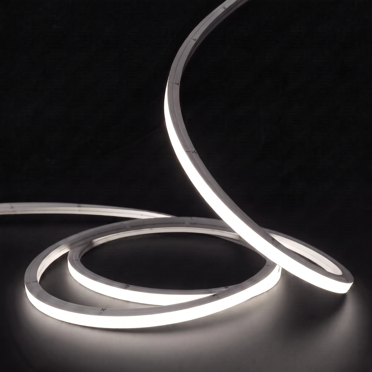 Neutral White 4000K LED Neon Flex 15x15mm Top Bend, low concentric coils with raised arc and colour glow on a black surface