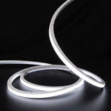 Cool White 6000K LED Neon Flex 15x15mm Top Bend, low concentric coils with raised arc and colour glow on a black surface
