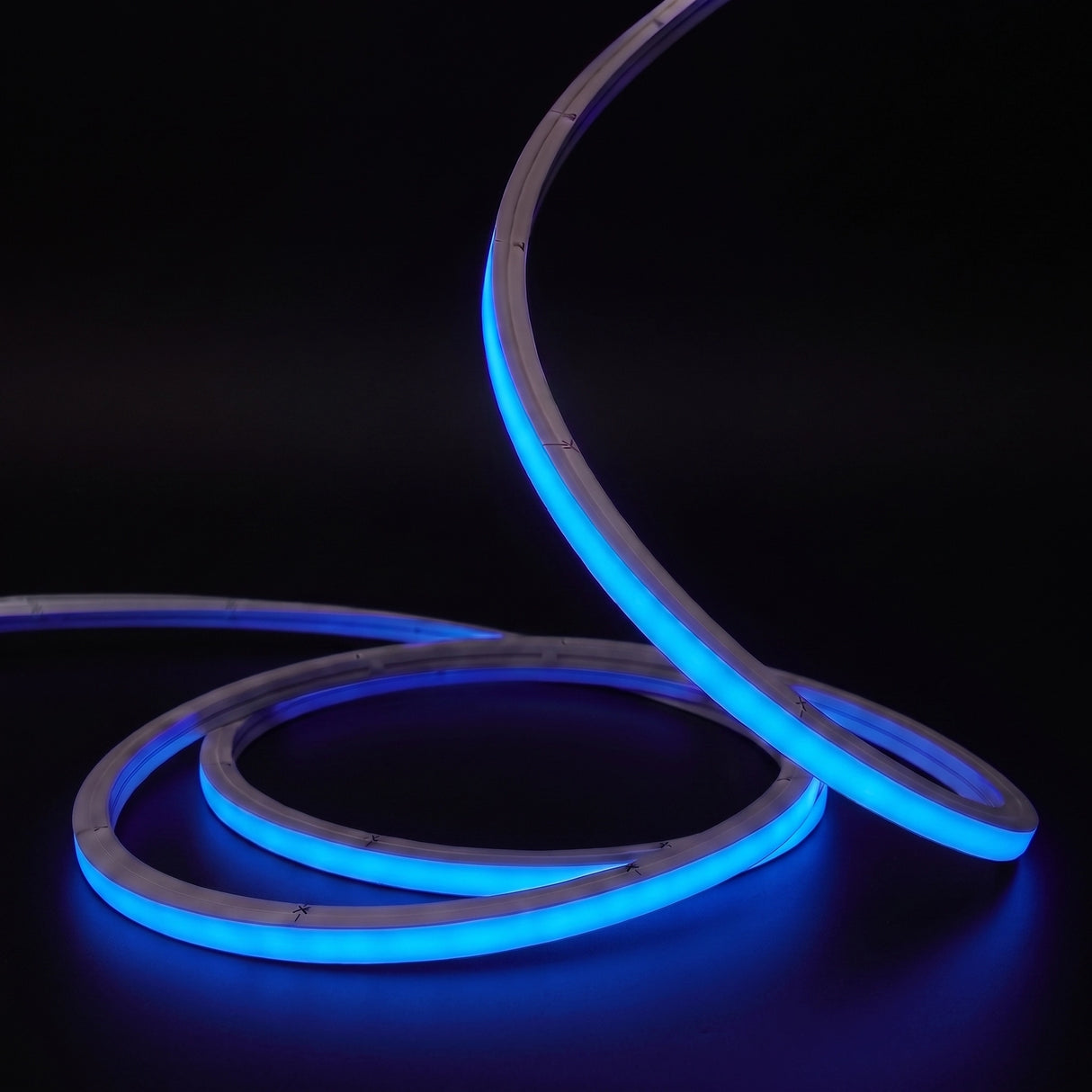 Blue LED Neon Flex 15x15mm Top Bend, low concentric coils with raised arc and colour glow on a black surface