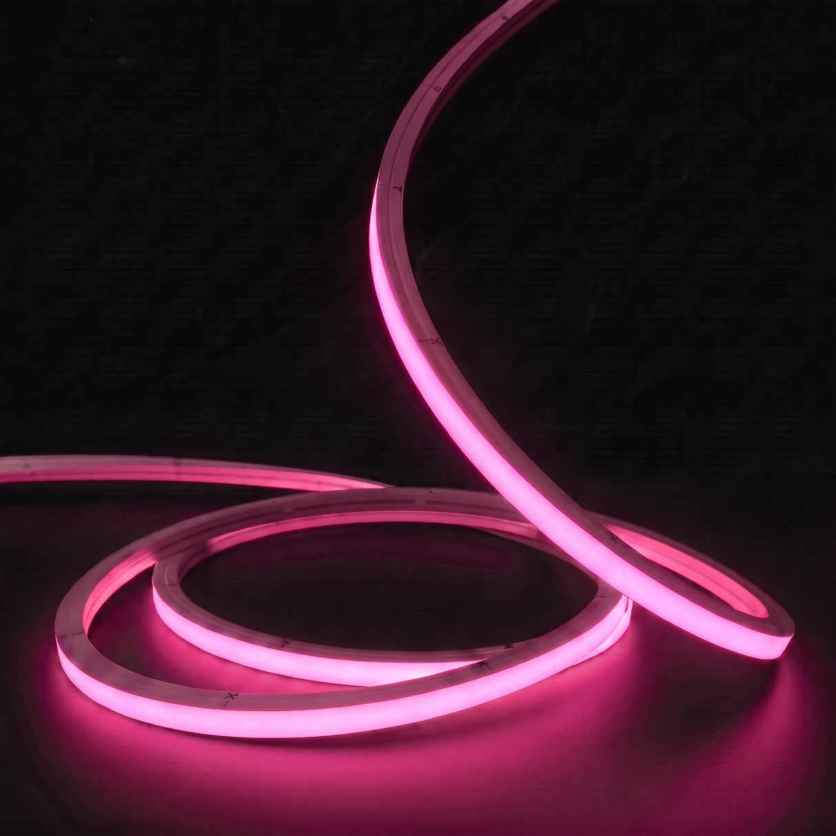 Pink LED Neon Flex 15x15mm Top Bend, low concentric coils with raised arc and colour glow on a black surface