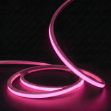 Pink LED Neon Flex 15x15mm Top Bend, low concentric coils with raised arc and colour glow on a black surface
