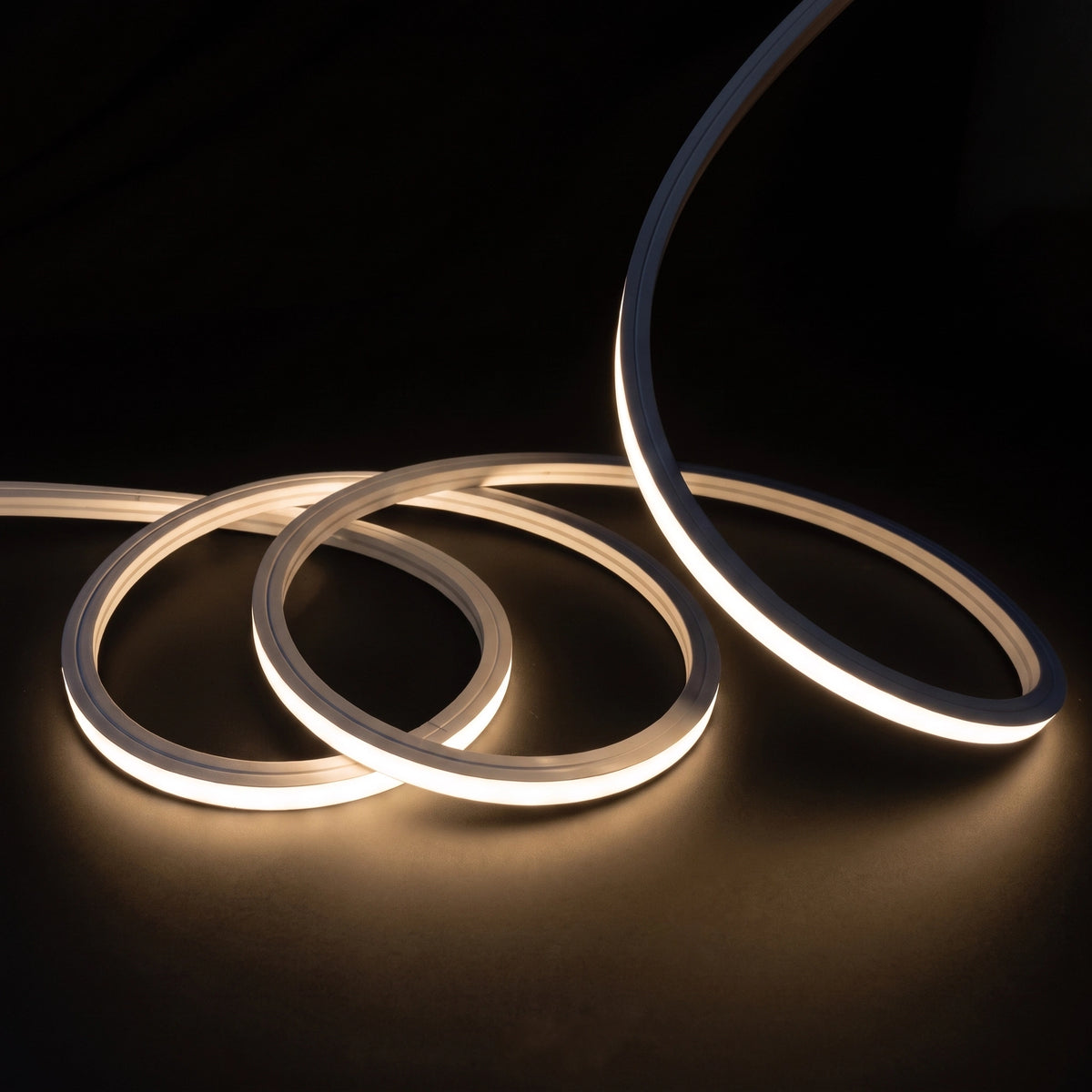 Warm White 3000K LED Neon Flex 15x15mm Top Bend, overlapping offset coils with raised arc and colour glow on a black surface