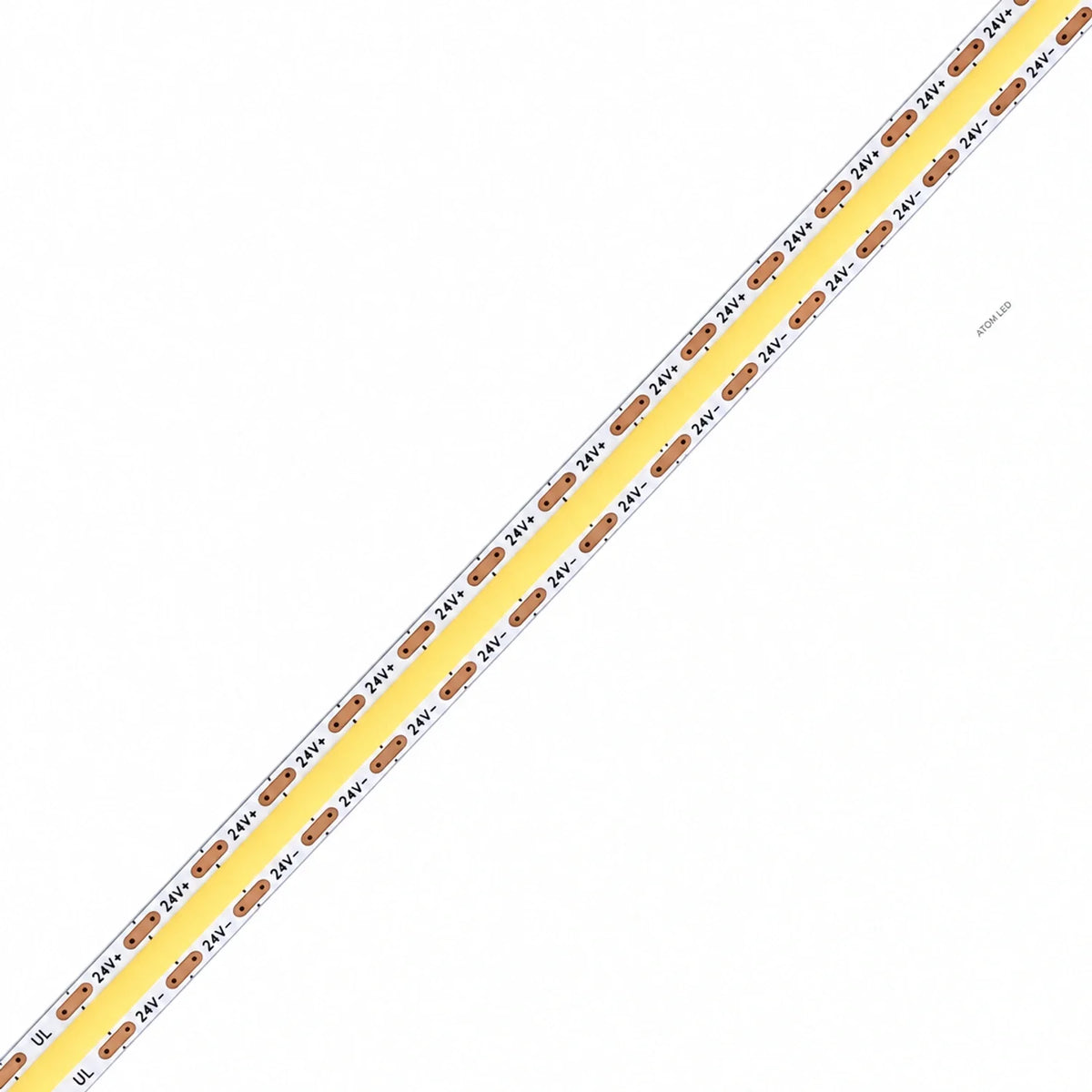 ATOM LED 24V 10mm COB LED strip close-up with white PCB, copper contact pads and yellow phosphor