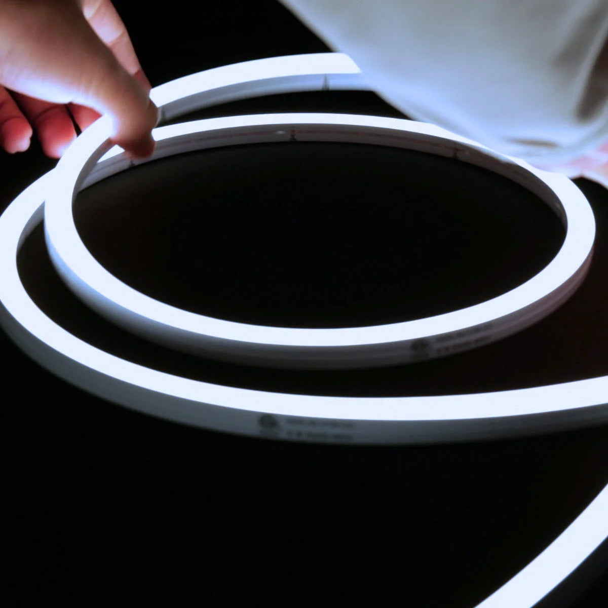 ATOM LED cool white 6000K 10x10mm side bend neon flex bending flat around an outdoor flower border — 48V IP67 waterproof