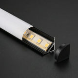 Black corner profile diffuser open showing LED strip and black end cap