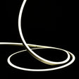 ATOM LED natural white 4000K 10x10mm side bend neon flex turning a 90° corner around an outdoor garden patio — 48V IP67 waterproof
