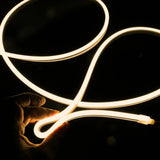ATOM LED warm white 3000K 10x10mm side bend neon flex bending flat around an outdoor flower border — 48V IP67 waterproof