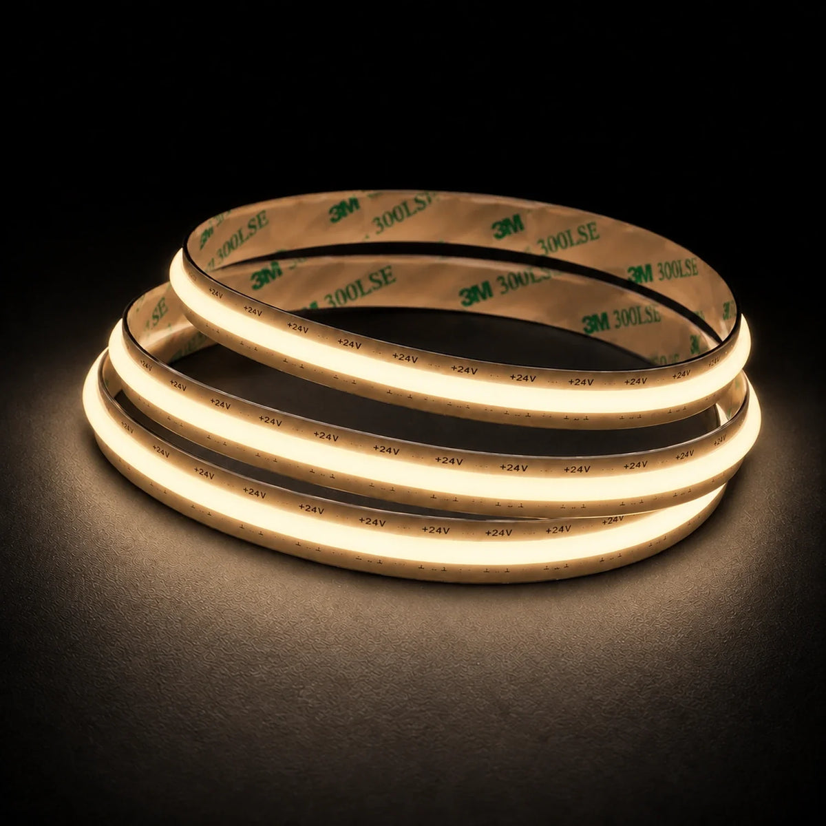 2700K Free Cut COB LED strip 24V 8mm IP20 illuminated coil on black background