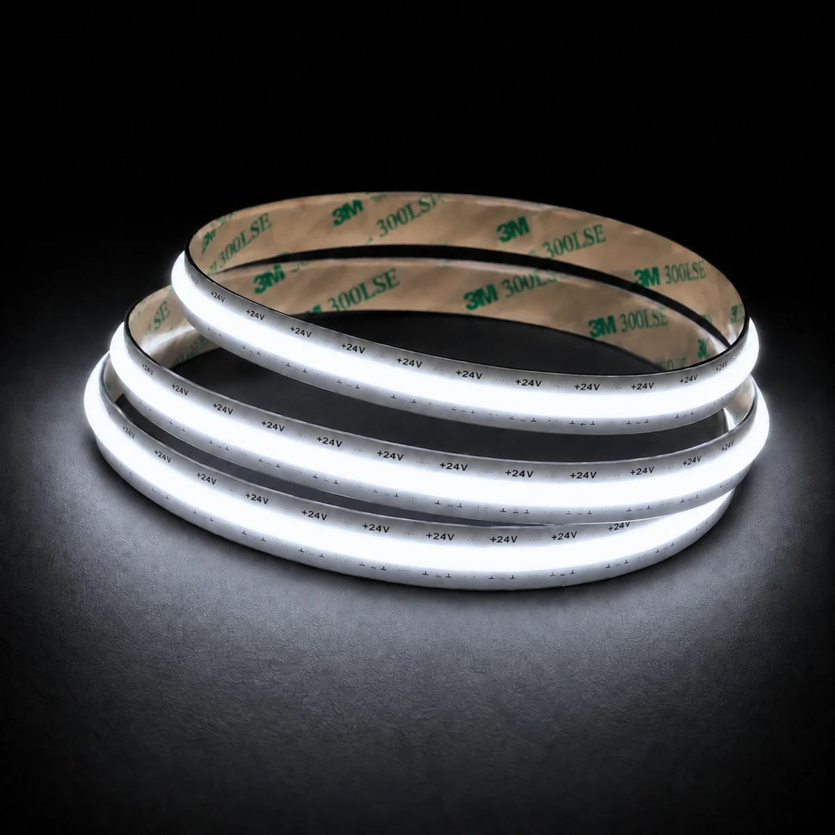 6500K Free Cut COB LED strip 24V 8mm IP20 illuminated coil on black background