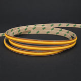 ATOM LED FreeCut COB LED strip switched-off coil with golden PCB and 3M Tape backing on charcoal background
