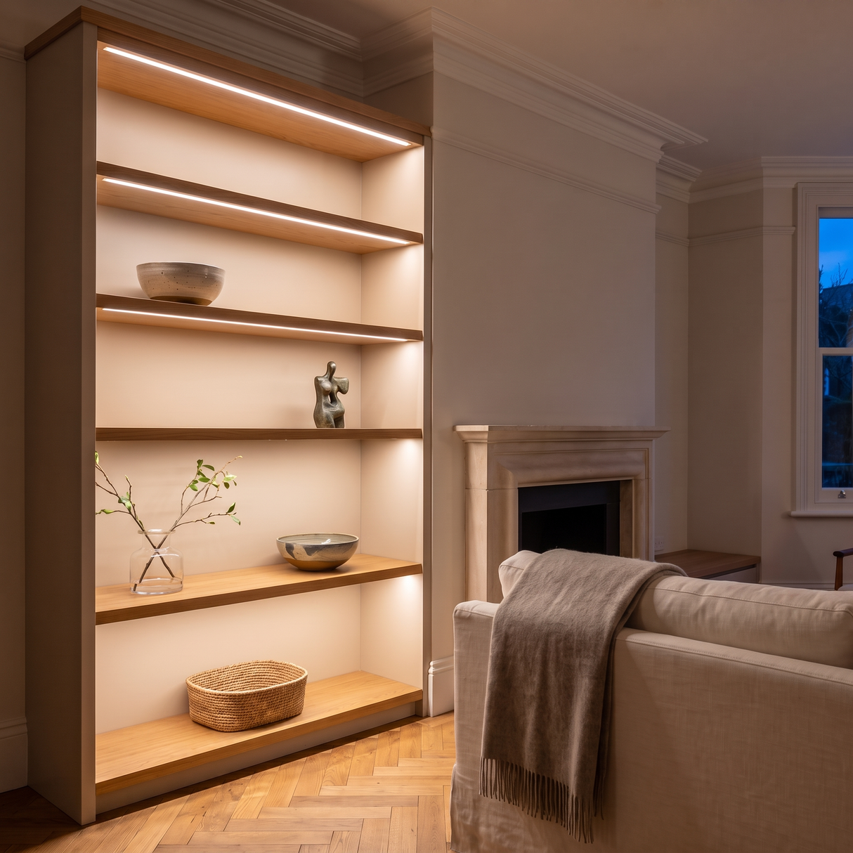 3000K white COB LED strip lighting beneath bespoke shelves in an elegant British home's sitting room