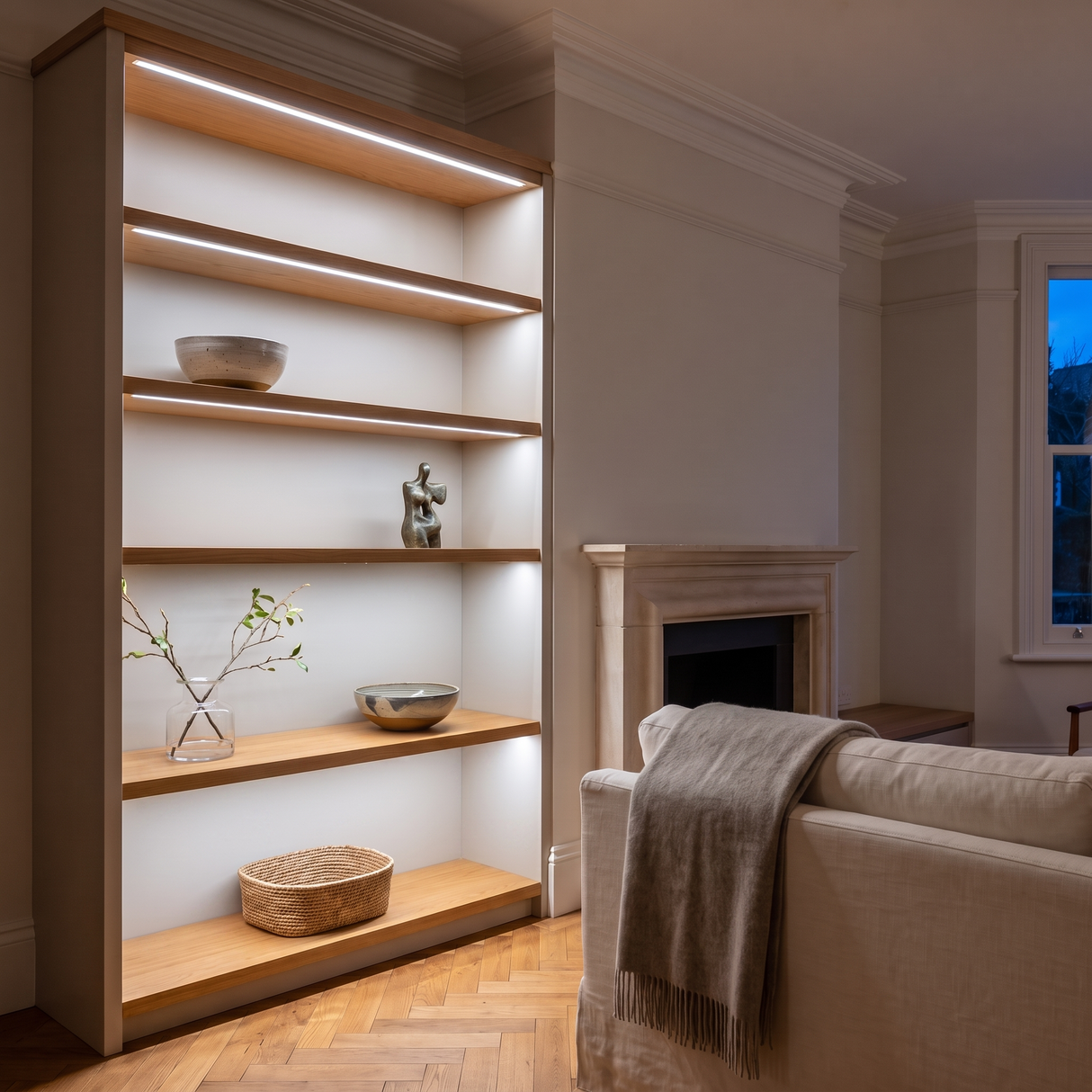 6500K white COB LED strip lighting beneath bespoke shelves in an elegant British home's sitting room