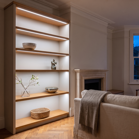 6500K white COB LED strip lighting beneath bespoke shelves in an elegant British home's sitting room