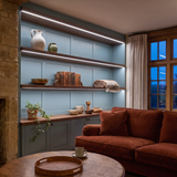 6500K white COB LED strip lighting beneath bespoke long display shelves in a beautiful British home