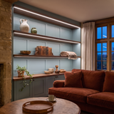 5000K white COB LED strip lighting beneath bespoke long display shelves in a beautiful British home