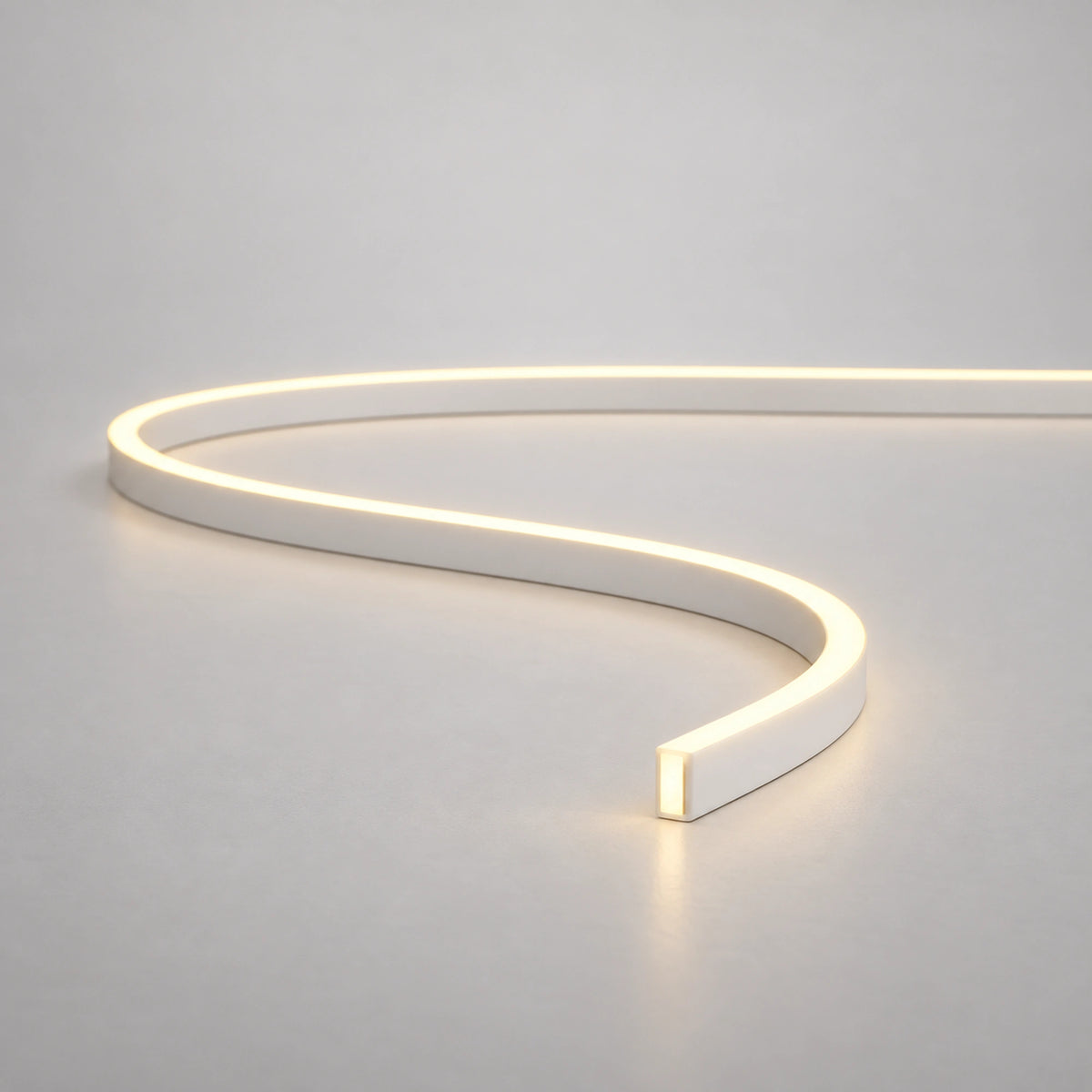 Warm-white mini neon flex curved on a light surface — product reference