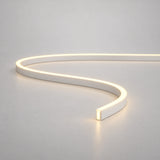 Warm-white mini neon flex curved on a light surface — product reference