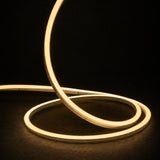 2700K side-bend Neon Flex raised in loops on a dark surface, colour-adjusted product photograph