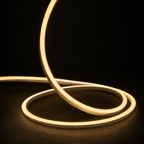 2700K side-bend Neon Flex raised in loops on a dark surface, colour-adjusted product photograph