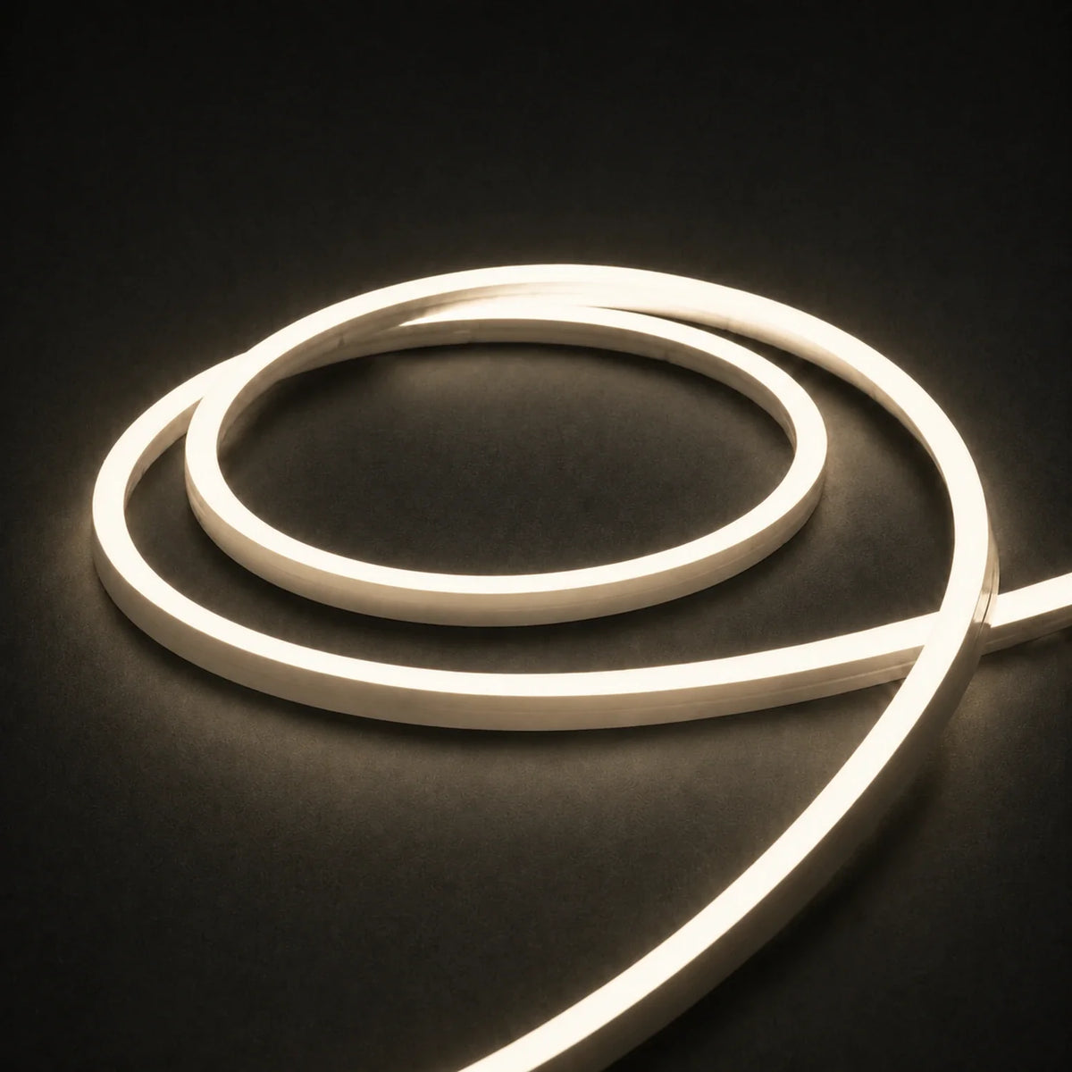 3000K side-bend Neon Flex coiled on a dark surface, colour-adjusted product photograph