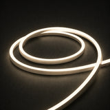 3000K side-bend Neon Flex coiled on a dark surface, colour-adjusted product photograph