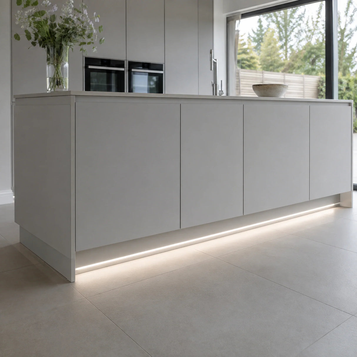 4000K 10×6mm Neon Flex lighting a kitchen plinth and kickboard, installation illustration