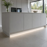 4000K 10×6mm Neon Flex lighting a kitchen plinth and kickboard, installation illustration