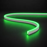 Green 6x12mm 12V IP65 LED neon flex with a domed luminous top in an S-curve on dark charcoal.