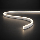 Natural White 4000K 6x12mm 12V IP65 LED neon flex with a domed luminous top in an S-curve on dark charcoal.