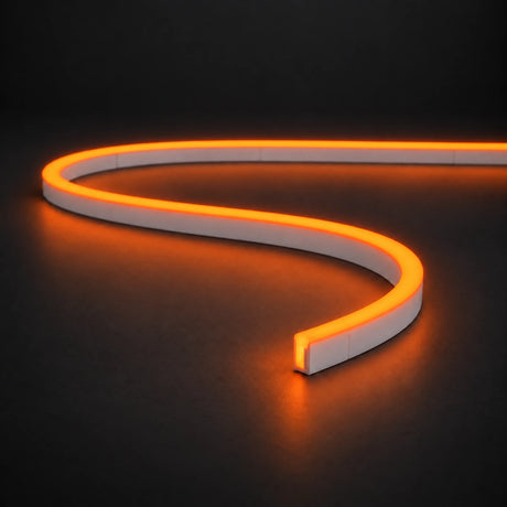 Orange 6x12mm 12V IP65 LED neon flex with a domed luminous top in an S-curve on dark charcoal.