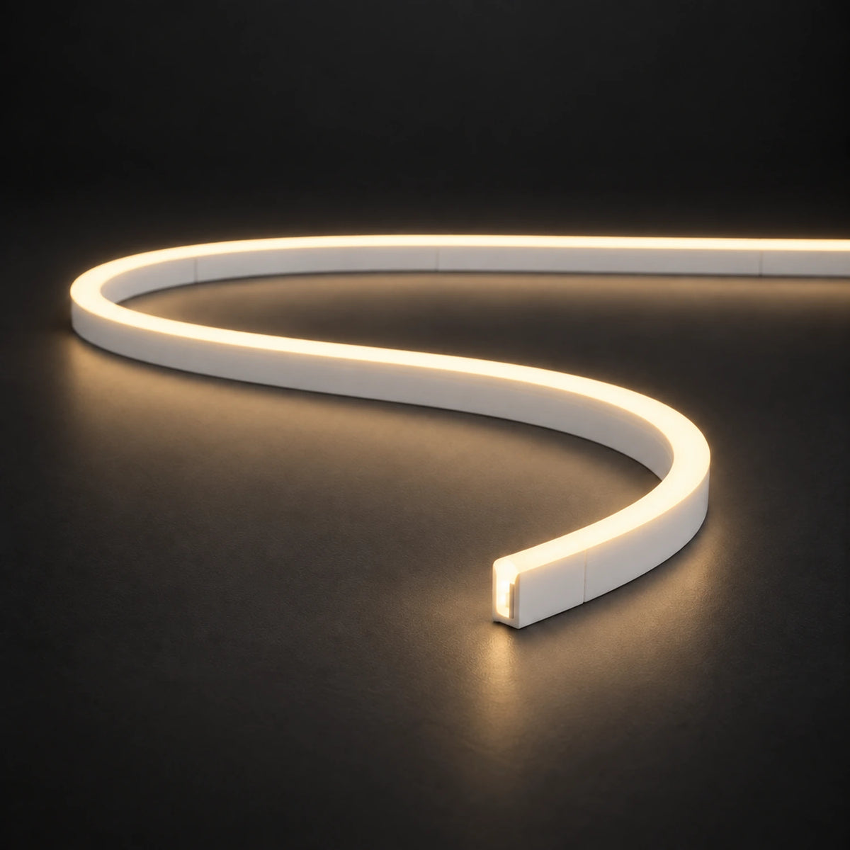Warm White 3000K 6x12mm 12V IP65 LED neon flex with a domed luminous top in an S-curve on dark charcoal.