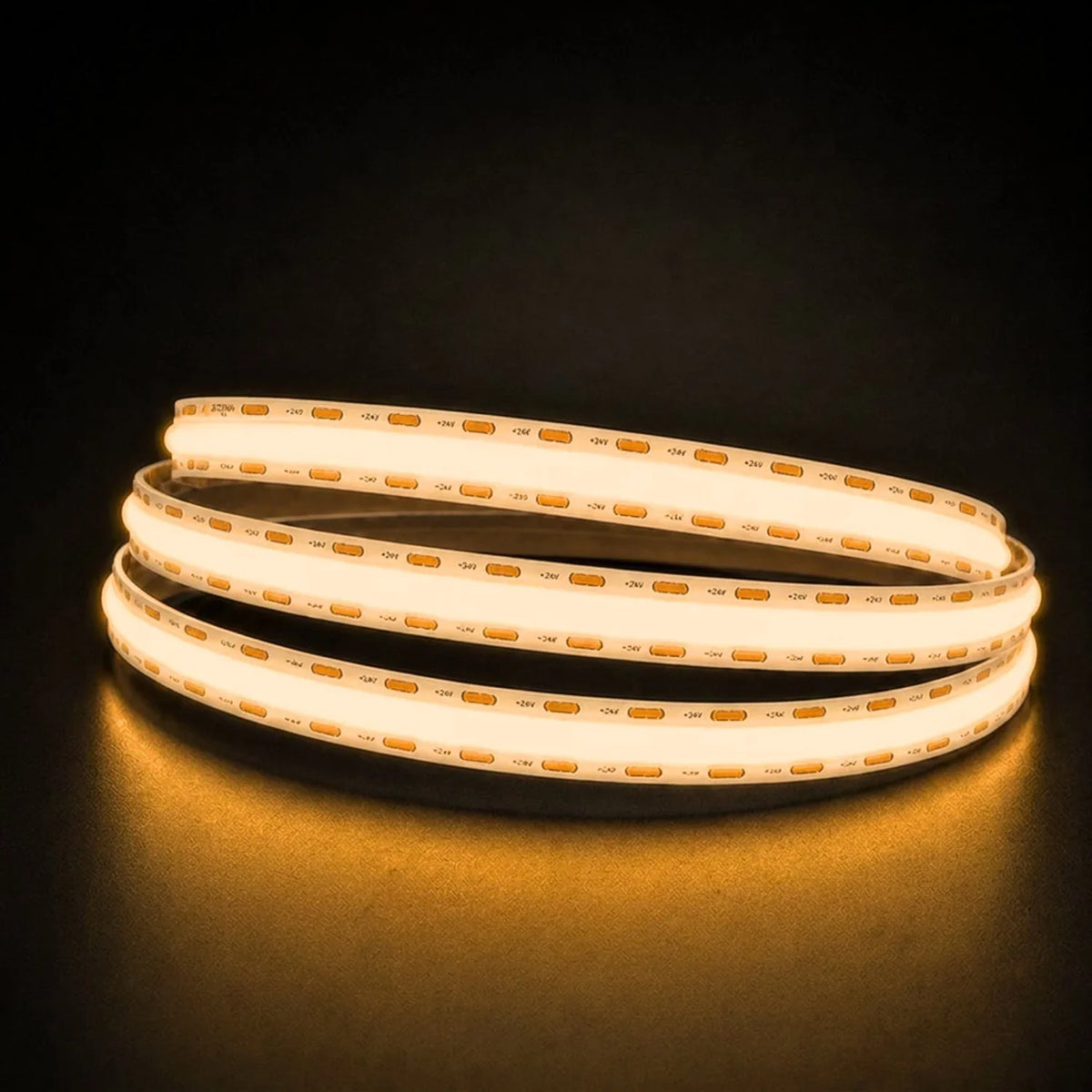 Warm White 2700K COB LED strip coil illuminated on a dark background, 24V DC and 10mm wide.