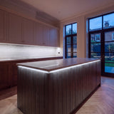 Cool White 6500K COB LED strip kitchen island lighting in a large British kitchen in the evening; installation illustration.