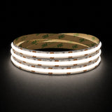 Natural White 4000K 24V 10mm COB LED strip shown illuminated in a coil on a dark background.